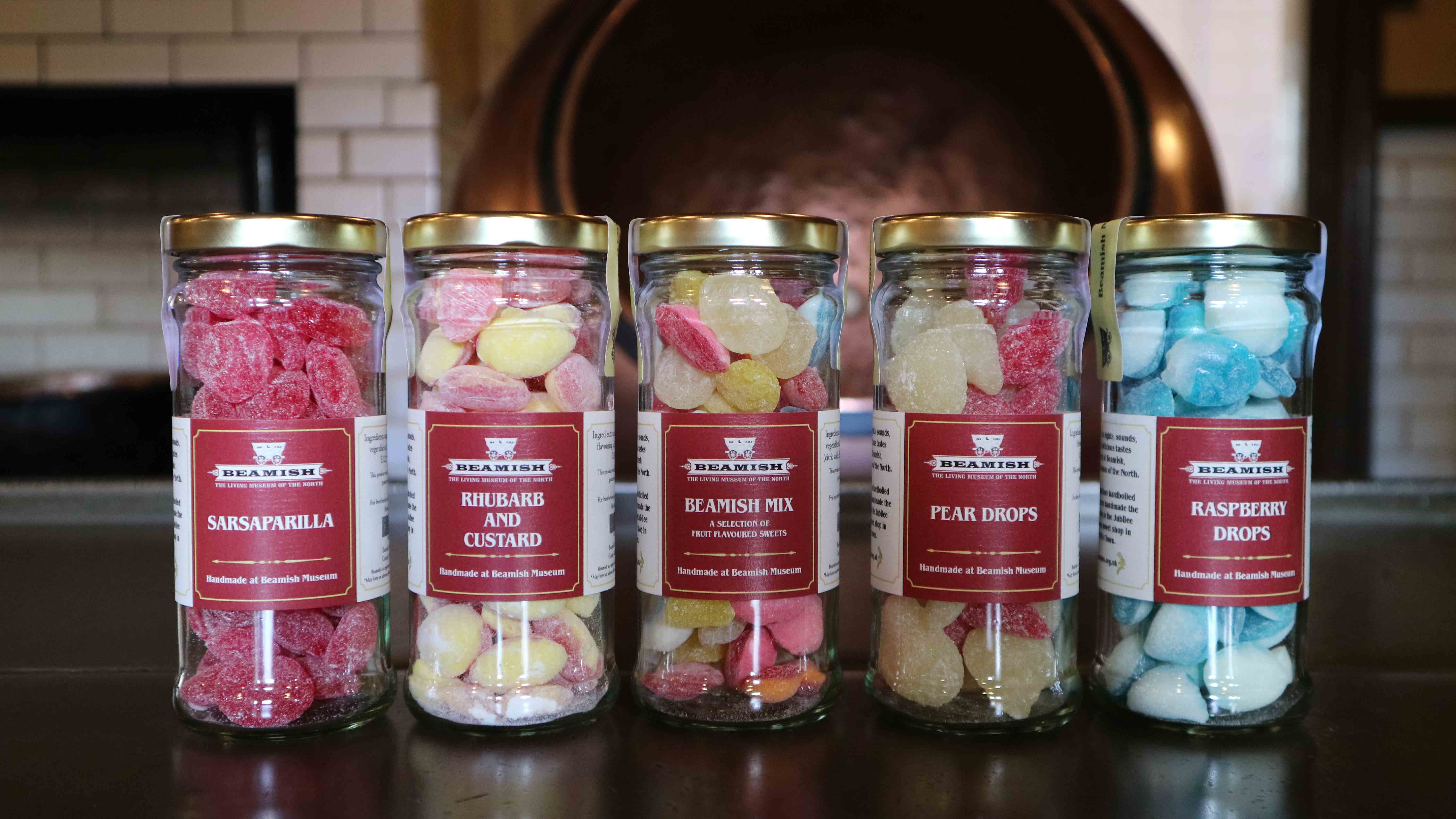 5 jars of hard boiled sweets in a row all with Beamish Museum branding on label.