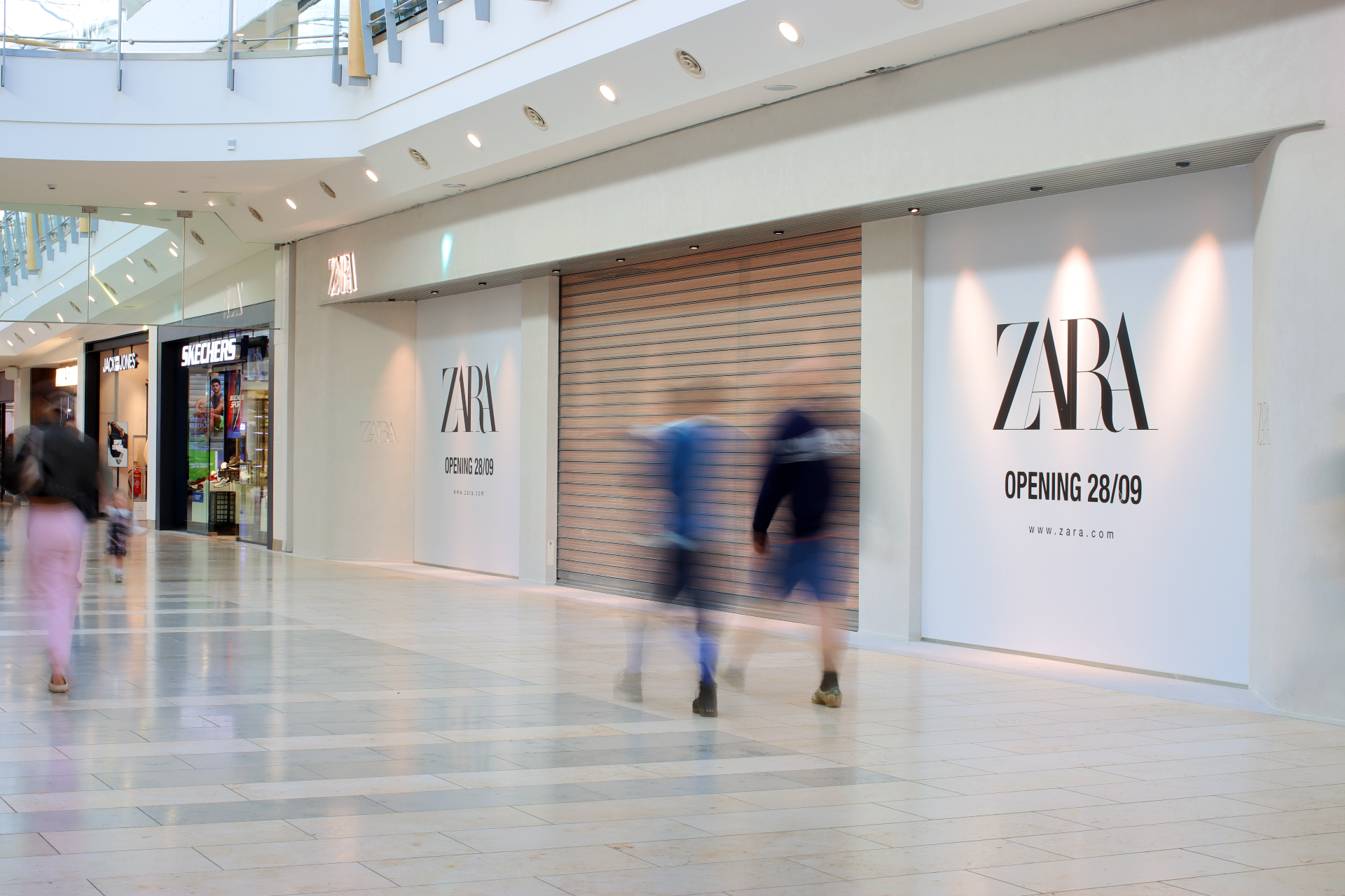 Exterior of new Zara store with boarded up windows.