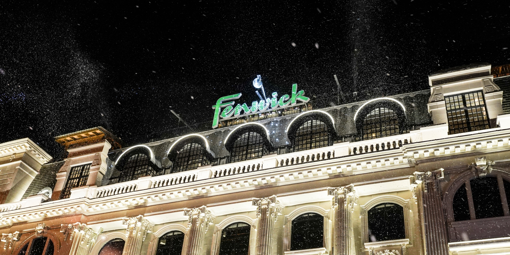 Image of Fenwick sign on their rooftop at night.