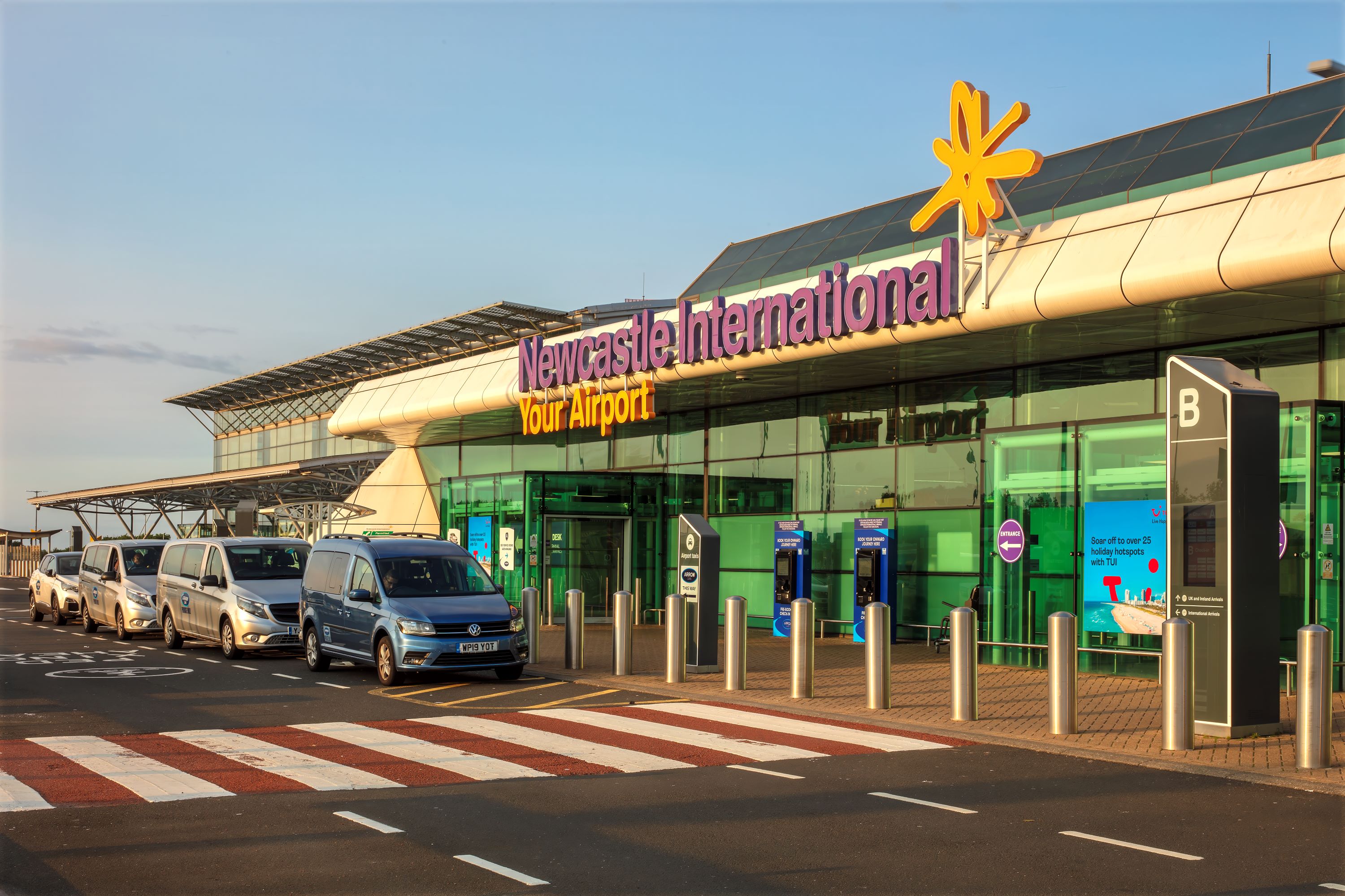 Front exterior of Newcastle Airport at sunset