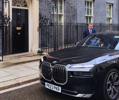 Image of black BMW car pulled up outside of 10 Downing Street front door