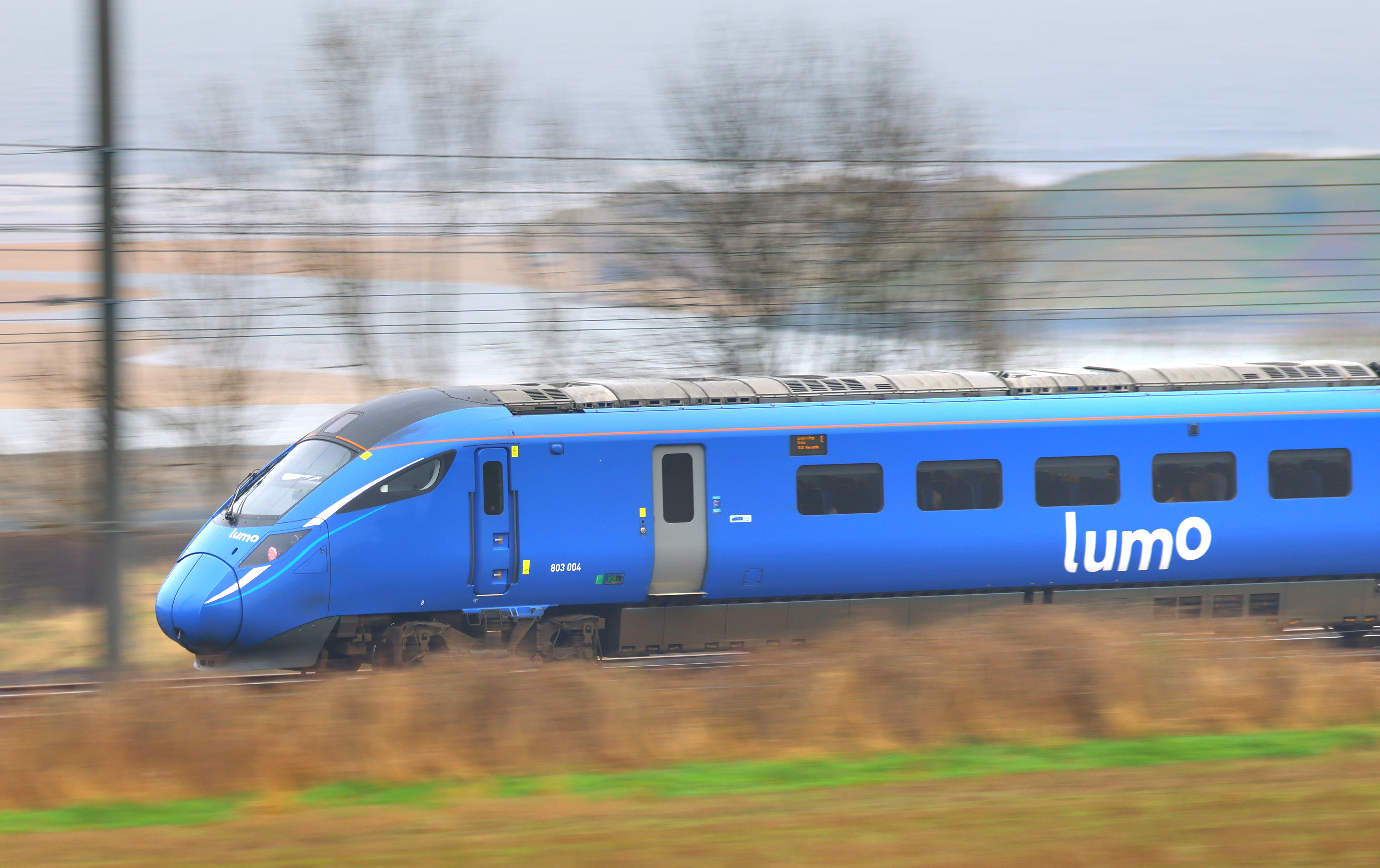 Lumo train racing through countryside