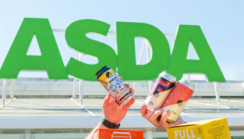 Colourful Full Circle Brew Co beer cans held up by hands in front of Asda sign