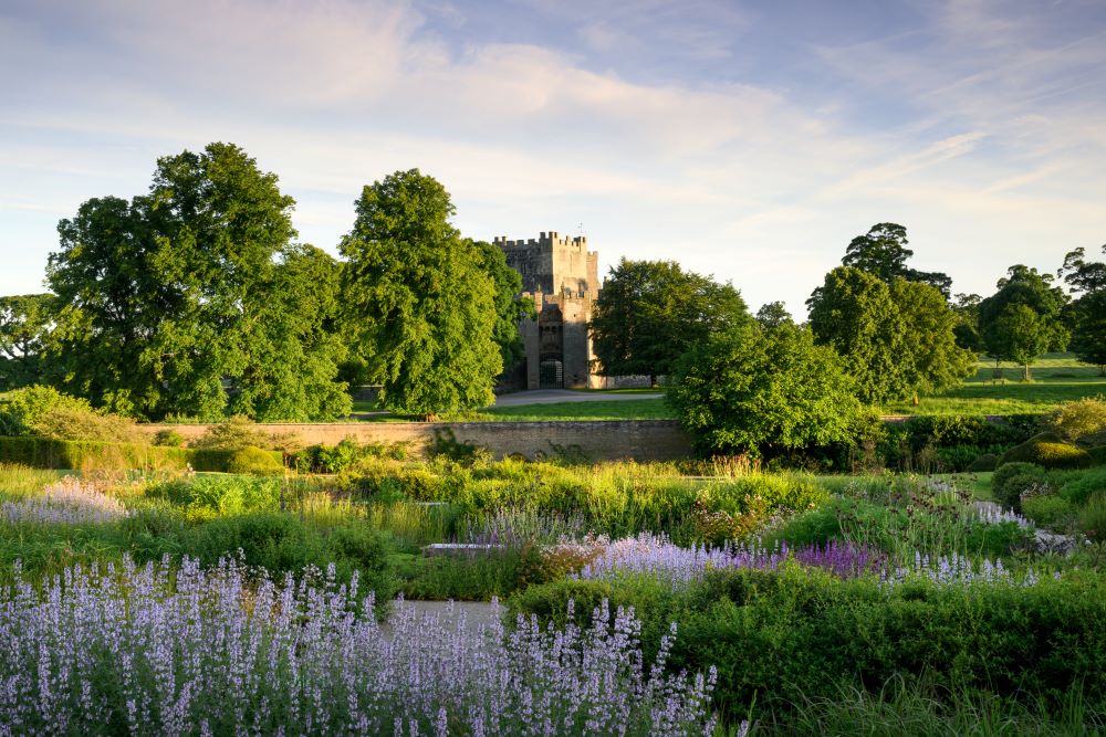 Lush green gardens with a castle in the background
