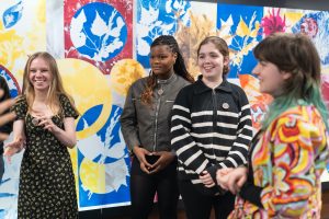 Young people smiling in art gallery