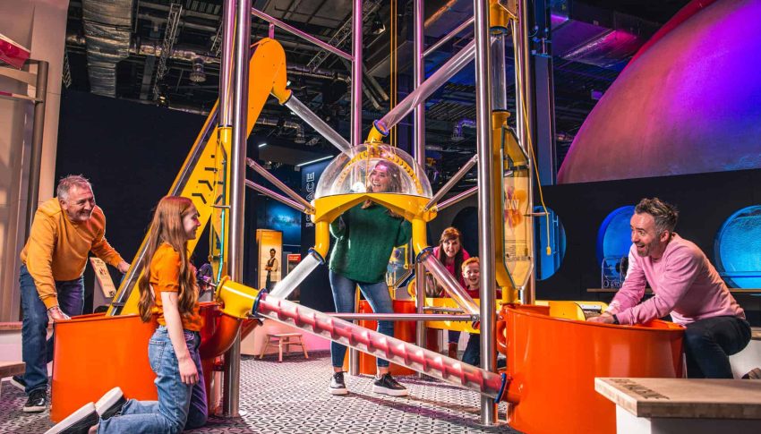 Adults and children playing in a construction themed exhibition at Centre for Life