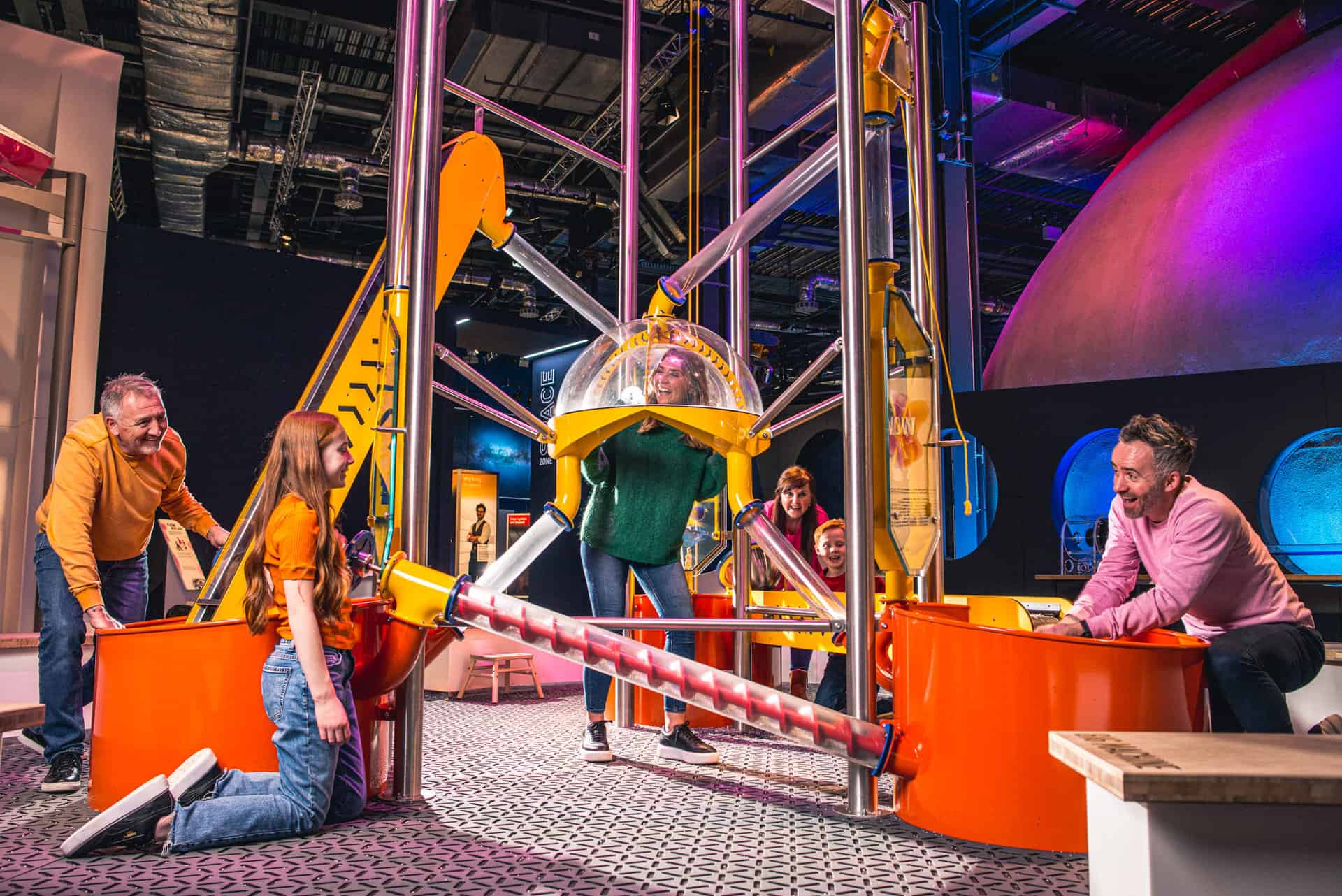 Adults and children playing in a construction themed exhibition at Centre for Life
