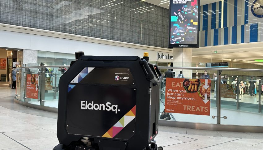 Cleaning robot with Eldon Square logo on the side cleaning floors in the shopping centre.