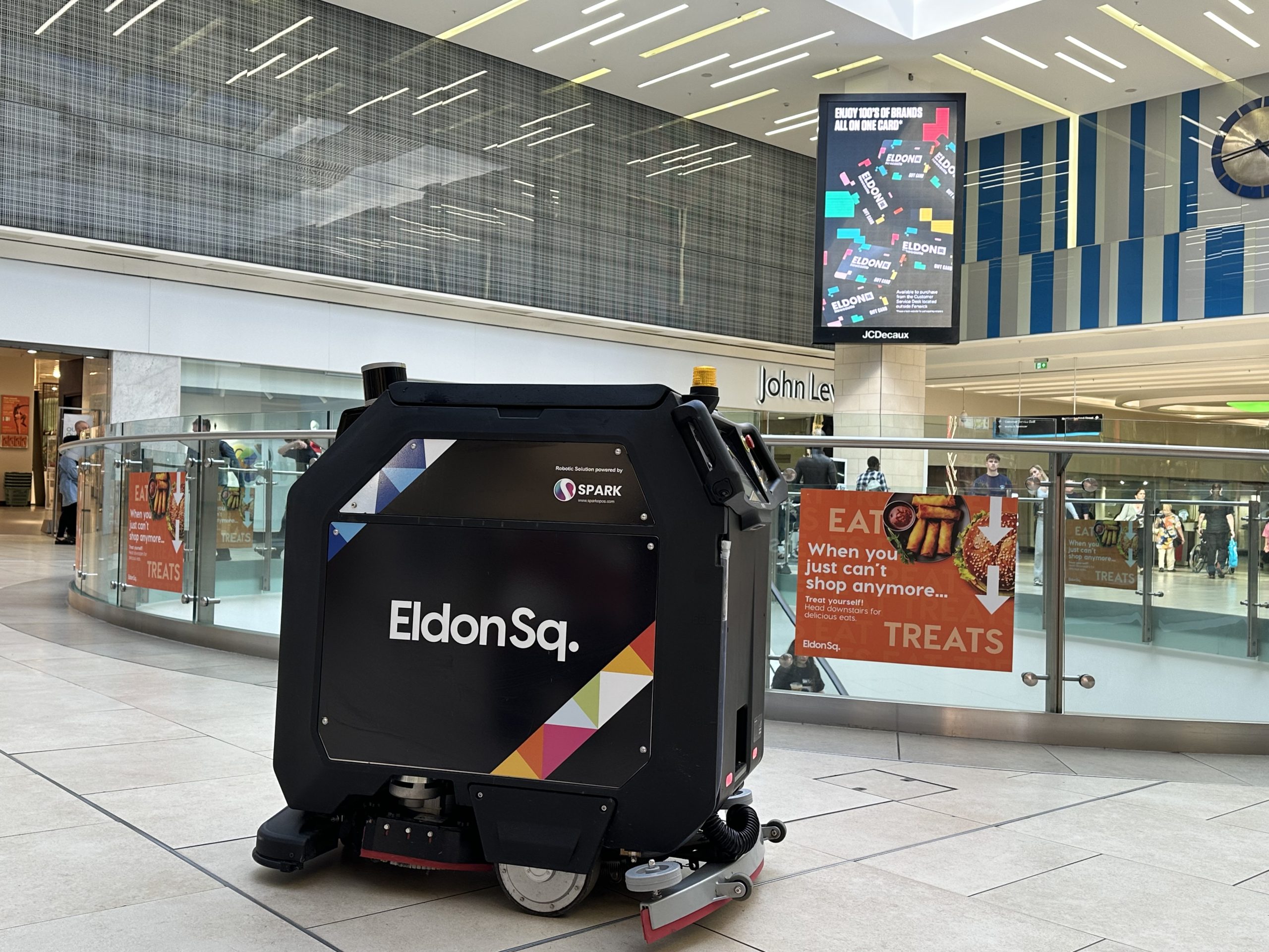 Cleaning robot with Eldon Square logo on the side cleaning floors in the shopping centre.