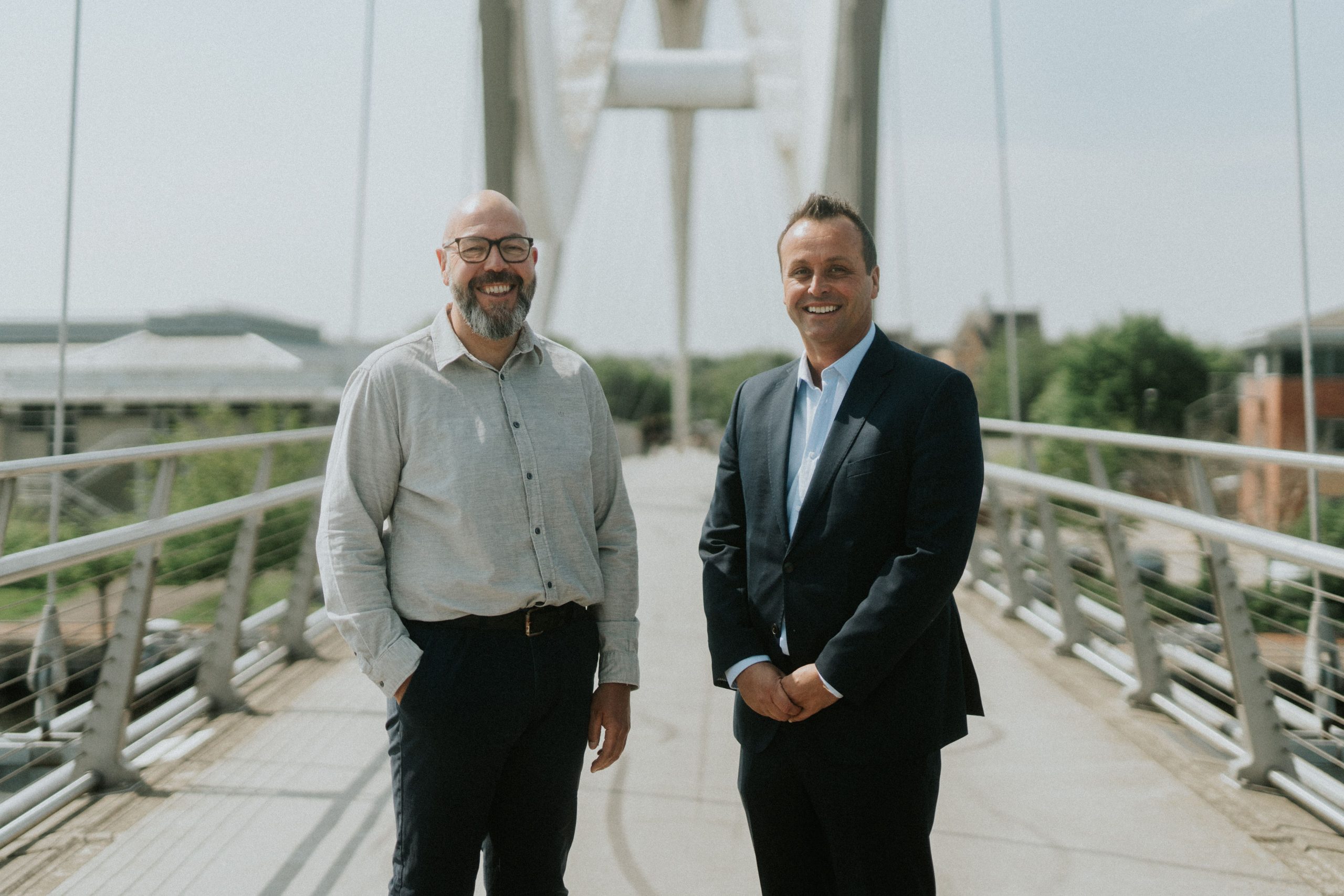 Lee and Steven headshot on a footbridge