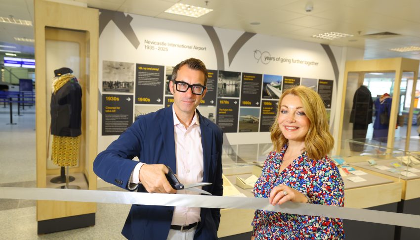 Keith and Alice cutting rope to new exhibition at Newcastle Airport