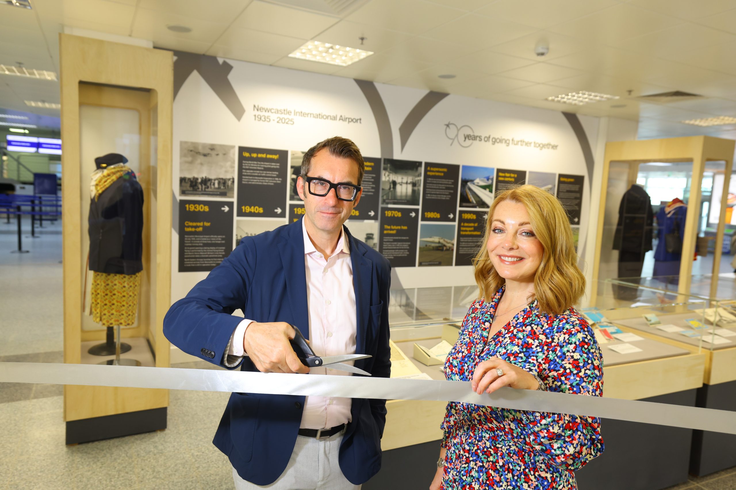 Keith and Alice cutting rope to new exhibition at Newcastle Airport