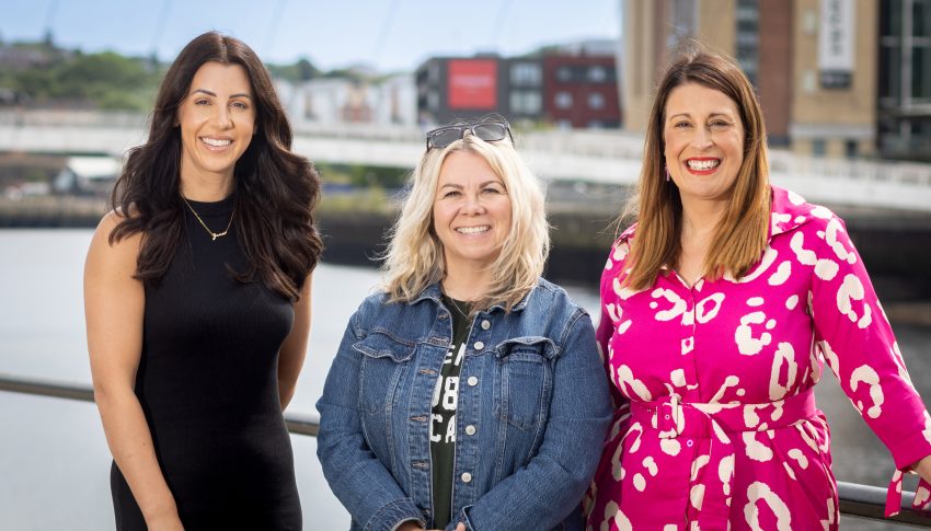 Jen, Angela and Kelly posing for headshots in front of the Millennium Bridge in Newcastle.