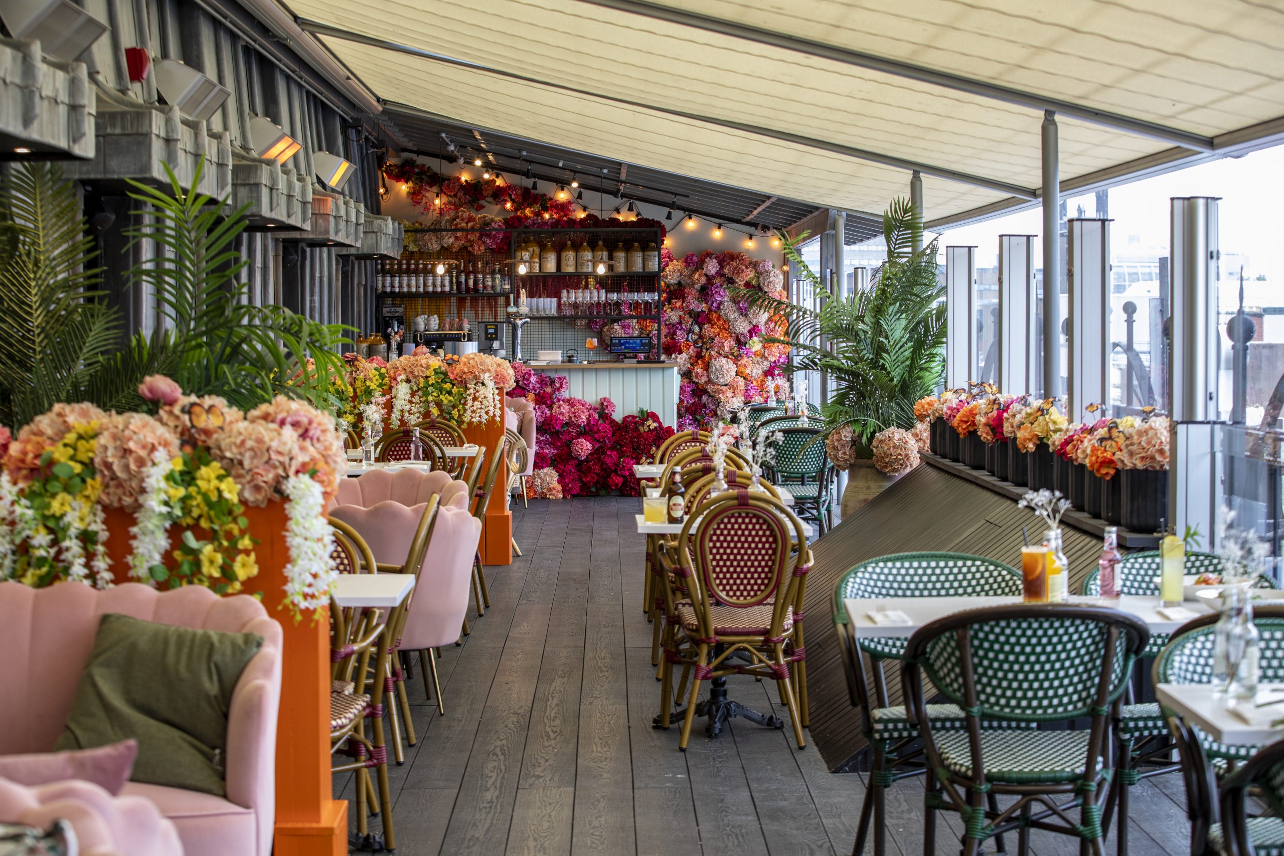 Rooftop restaurant at Fenwick decorated with colourful flowers and foliage
