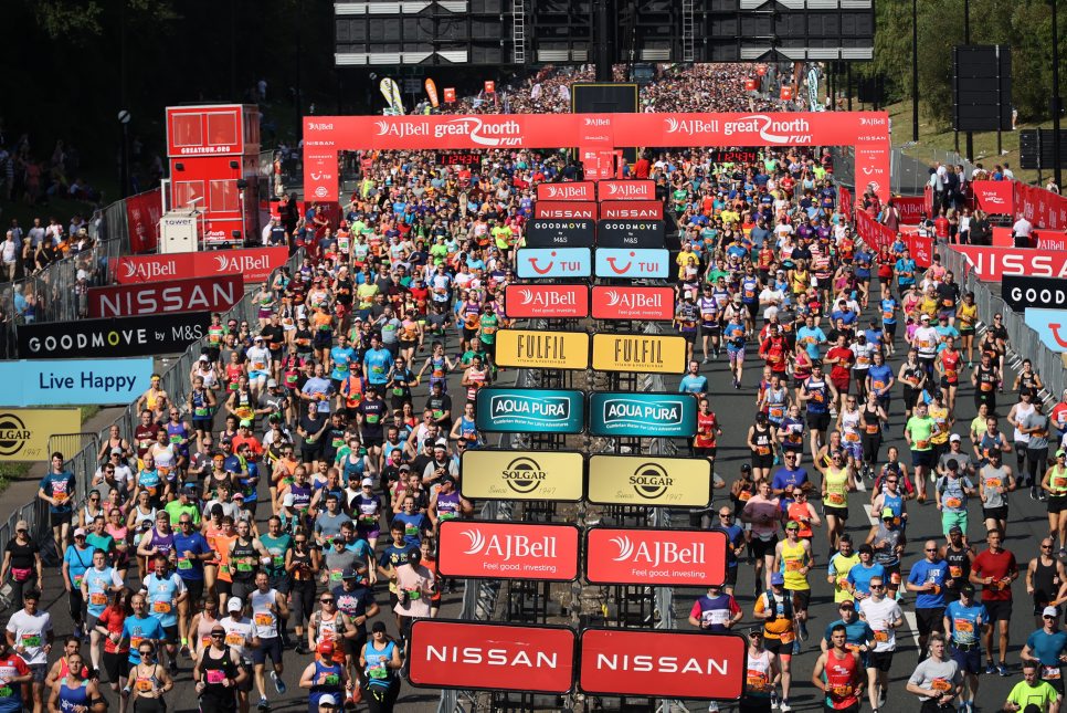 Starting line at the Great North Run with thousands of runners on the street.