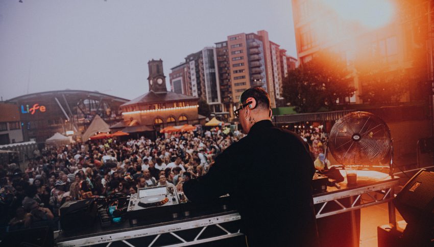 Stage view of Gok Wan djing in Newcastle with audience dancing in the background