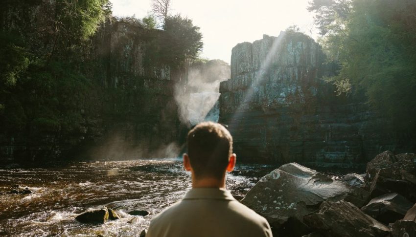 Person looking ahead to High Force Waterfall.