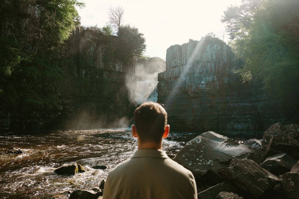 Person looking ahead to High Force Waterfall.