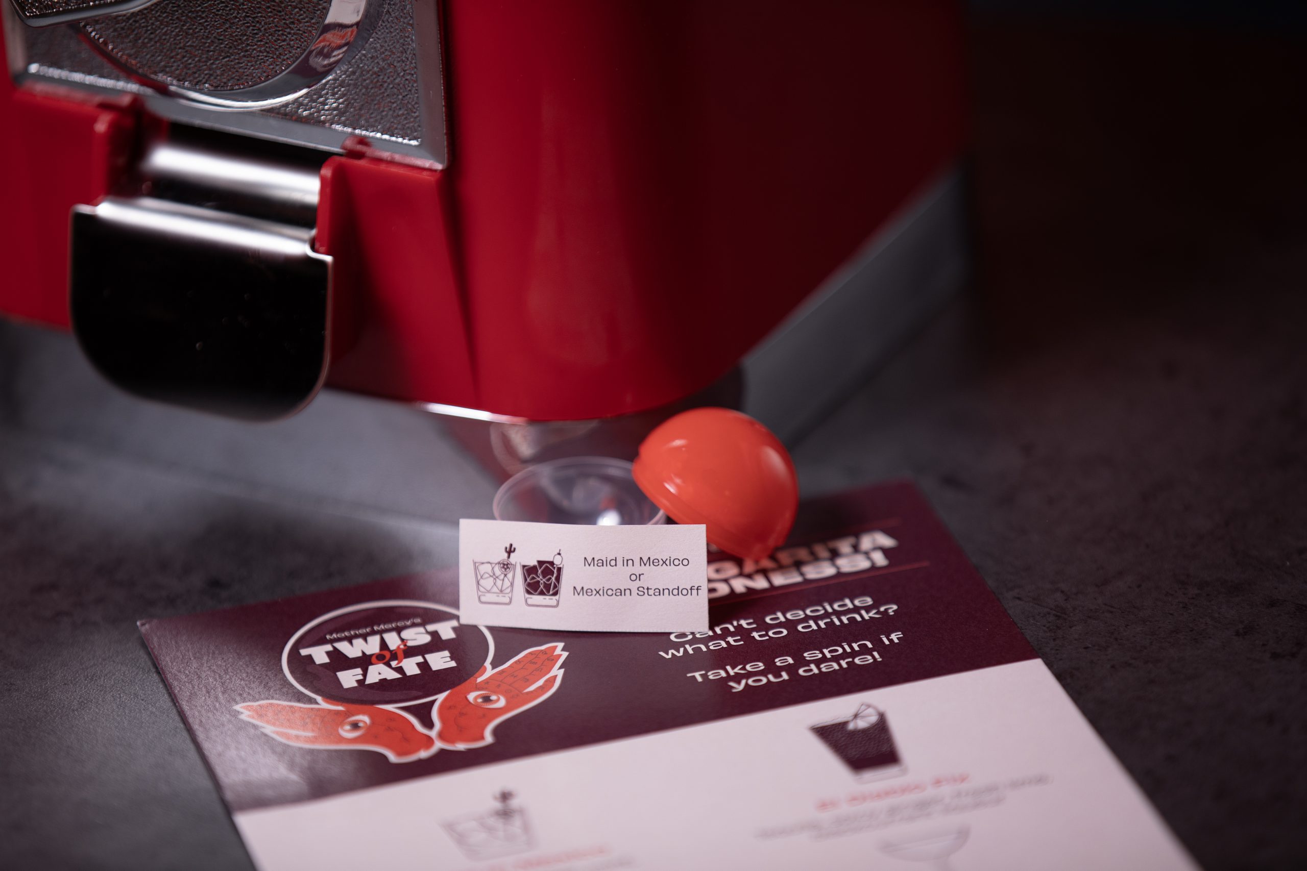 Image of the Mother Mercy Twist of Fate machine and label which has been won which gives a choice of two cocktails.