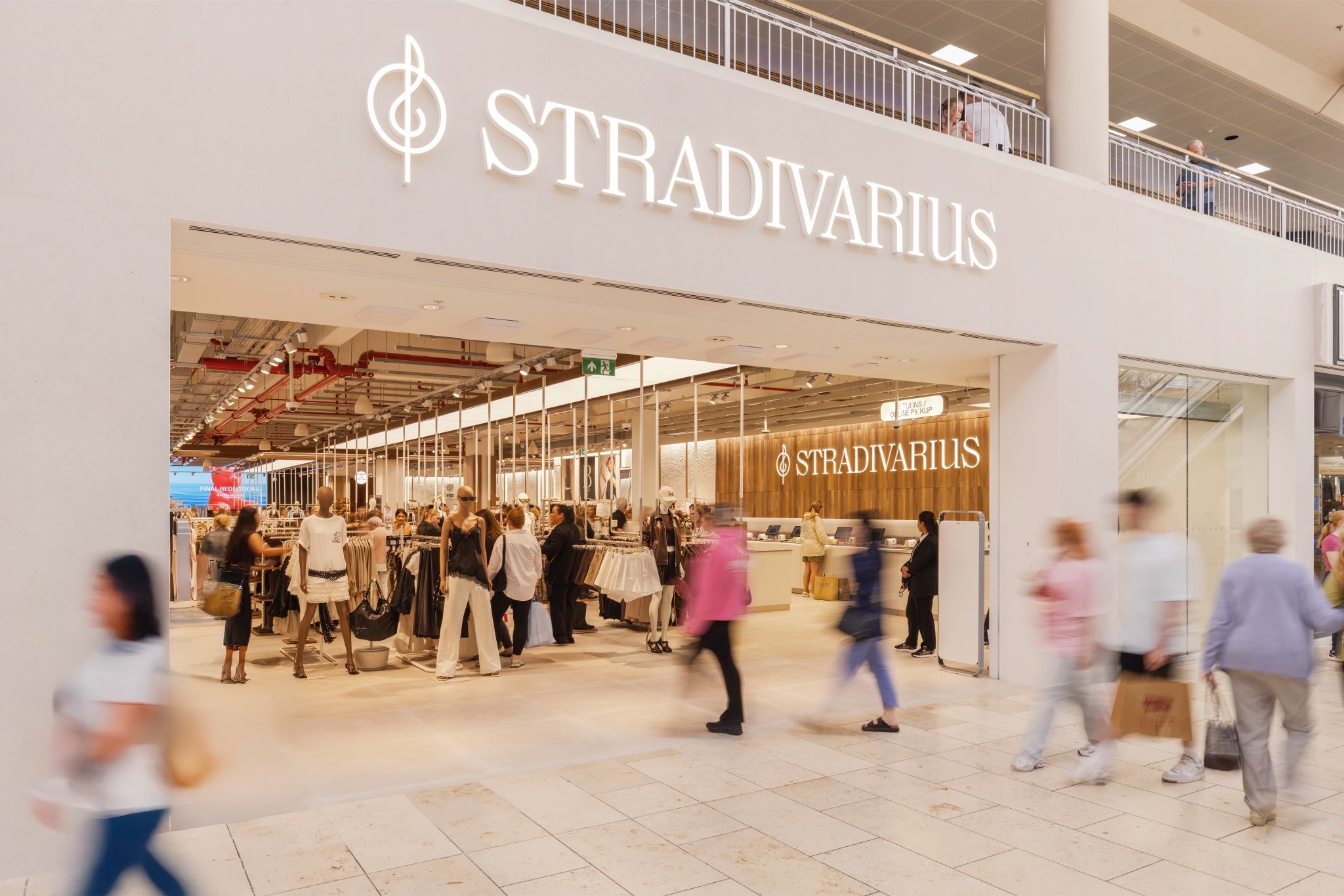 Stradivarius store front in Metrocentre with people walking through the front door.