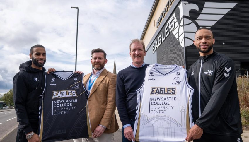 Newcastle Eagles Player Josh Ward Hibbert with Newcastle College Deputy Principal Alan Fenton, Eagles Managing Director Paul Blake and Player Marco Anthony holding the home and away basketball jerseys outside the Eagles stadium.