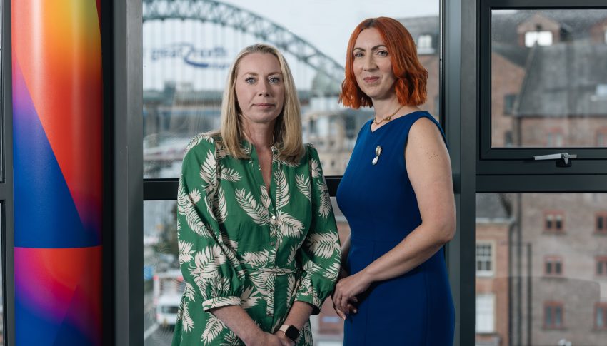 Gemma and Louise in Ward Hadaway office with Tyne Bridge outside the window in the background.