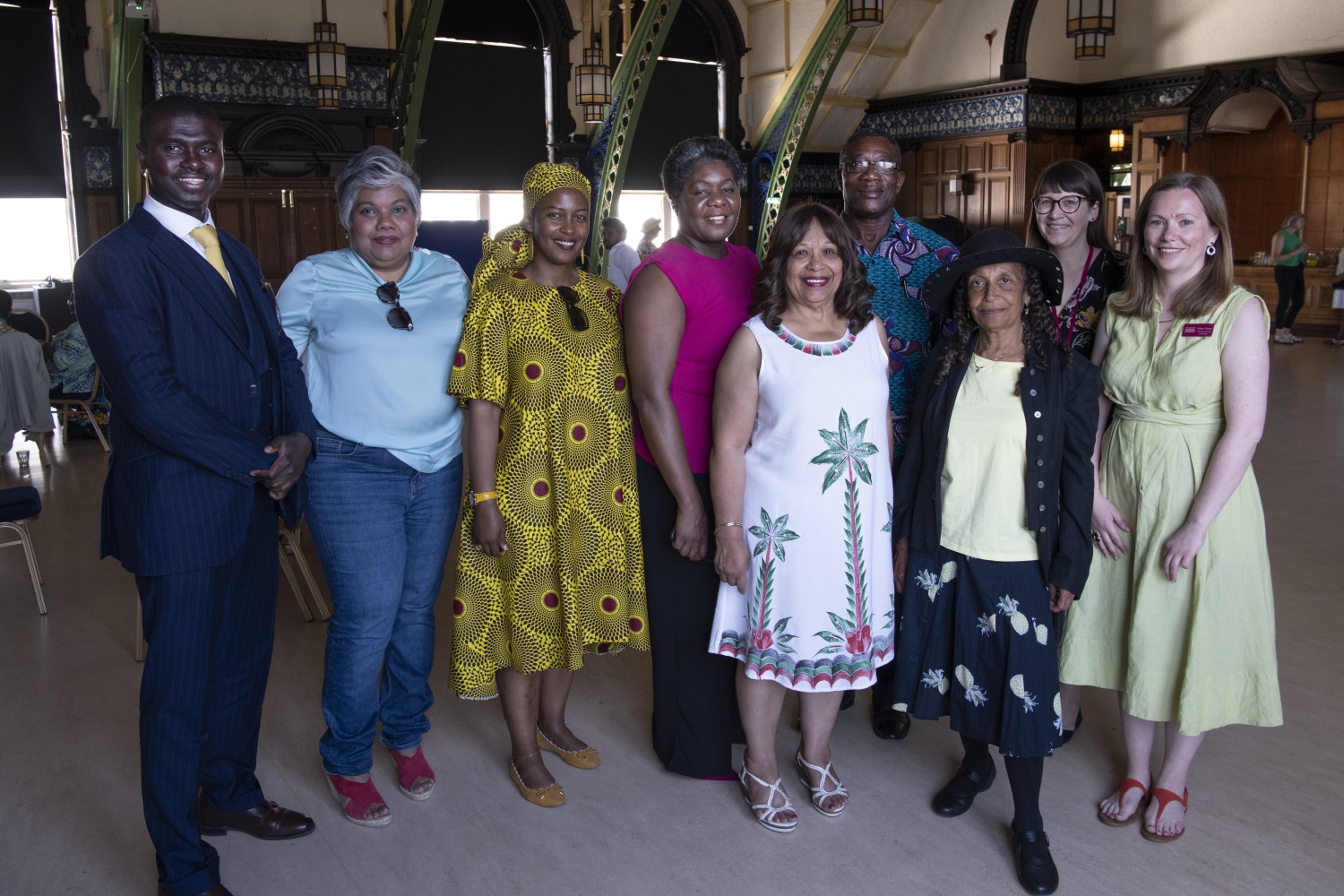 Group of people in brightly coloured and patterned clothes posing together in the Discovery Museum.