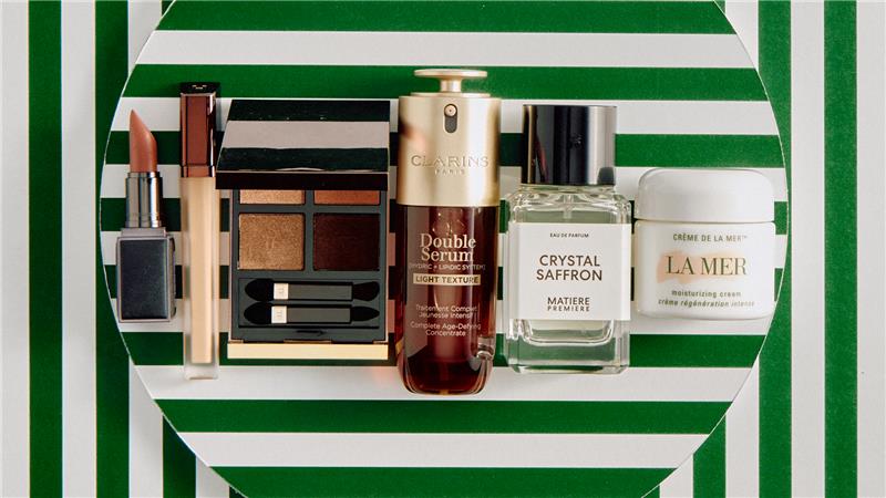 Various beauty items positioned on top of green and white striped material