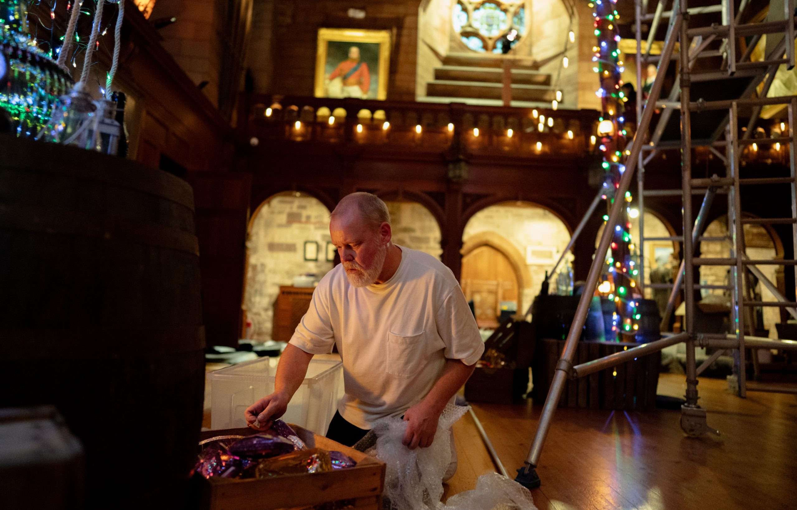 Person decorating a large room in Bamburgh Castle for Christmas