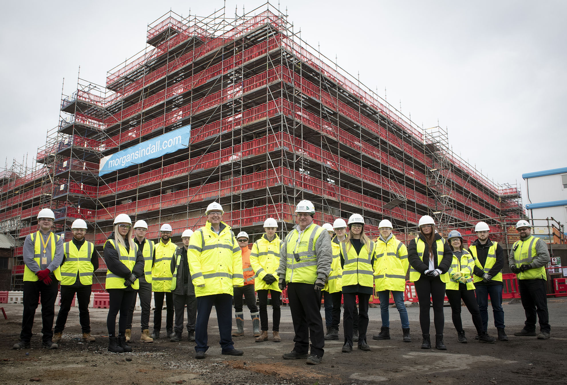 Group of Gateshead College students wearing PPE stood in front of building site.