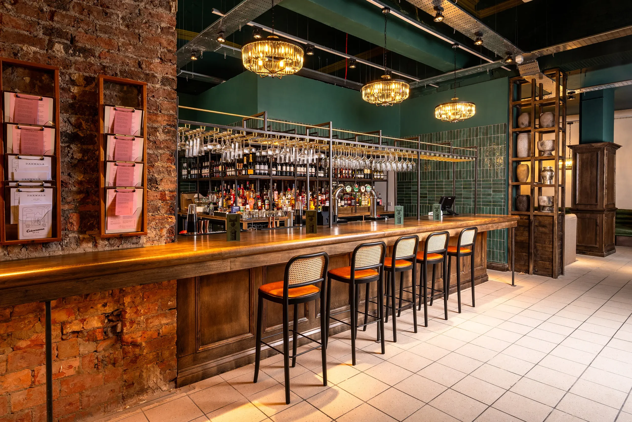 Dakwala bar with green walls and orange stools.