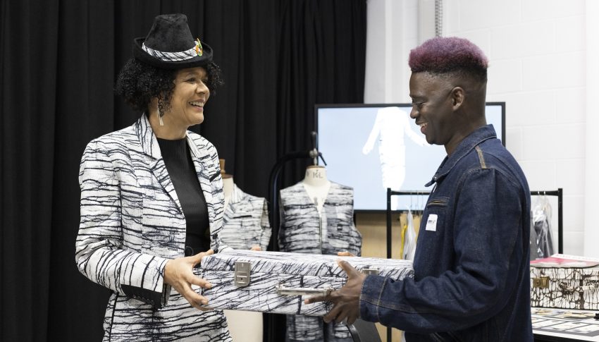 Dame Chi Onwurah MP wearing her investiture outfit with Lamin Gibba