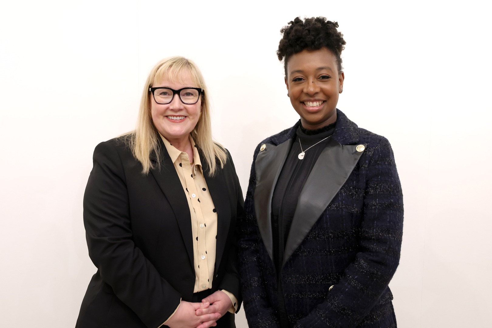 Karen and Yolanda in black suits.