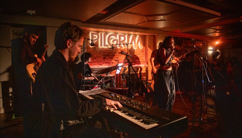 Mercury Fringe gig under orange lights.