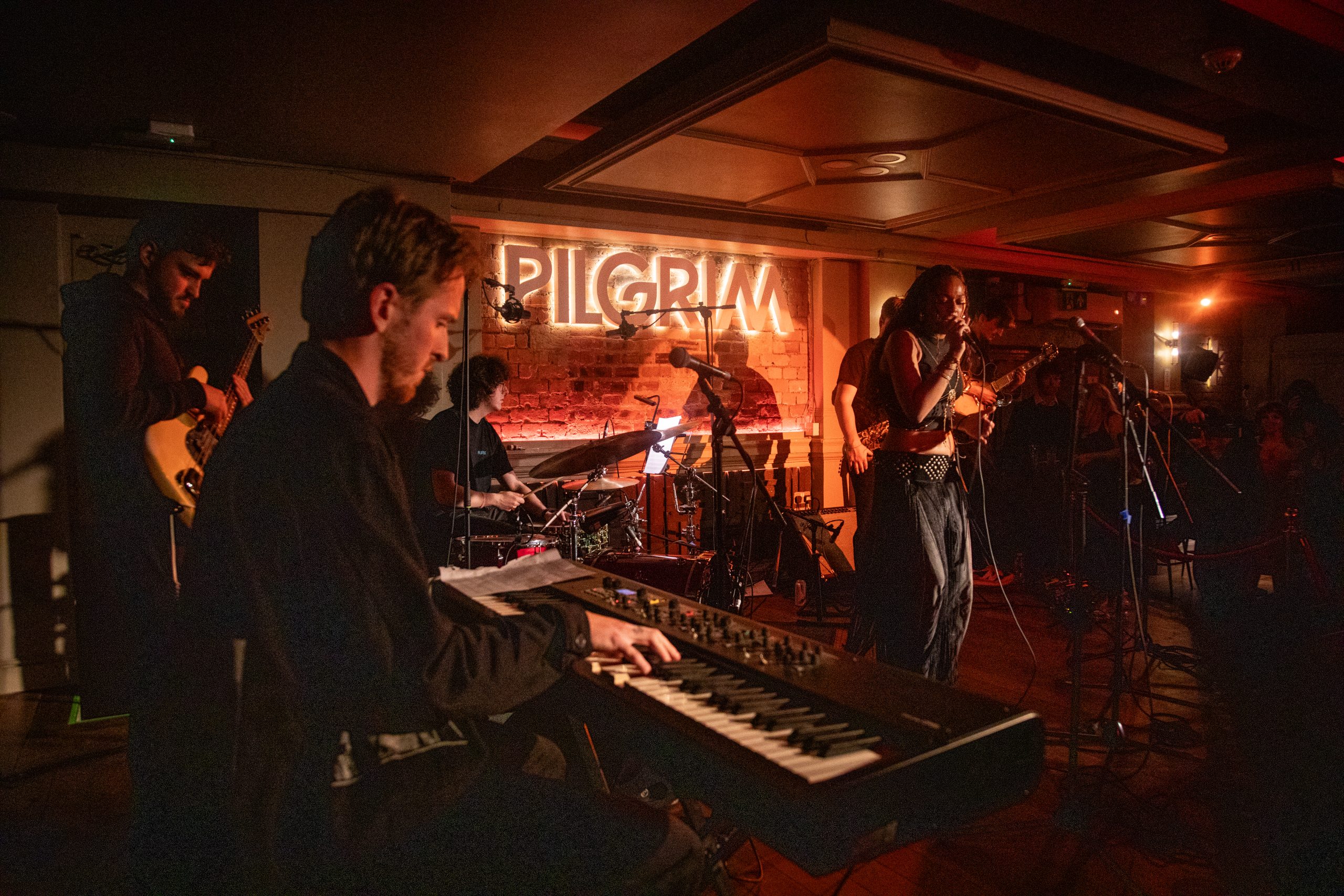 Mercury Fringe gig under orange lights.